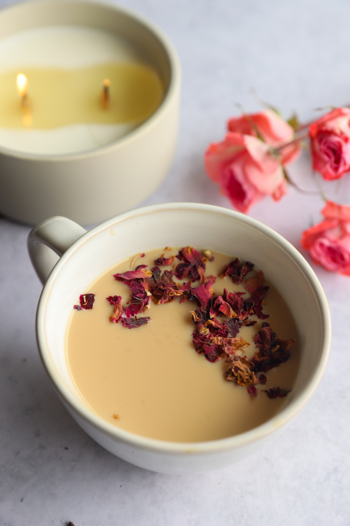 Rose Petal Milk Tea in a cup with rose petals on the side