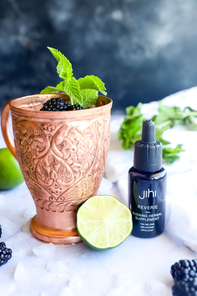 Fresh blackberry mule mocktail garnished with lime slices and blackberries