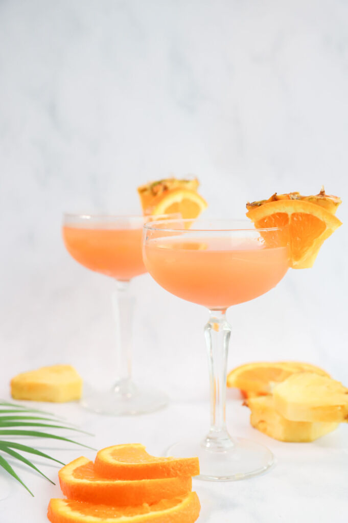 Pineapple infused Cinderella mocktail in a glass with fresh pineapple