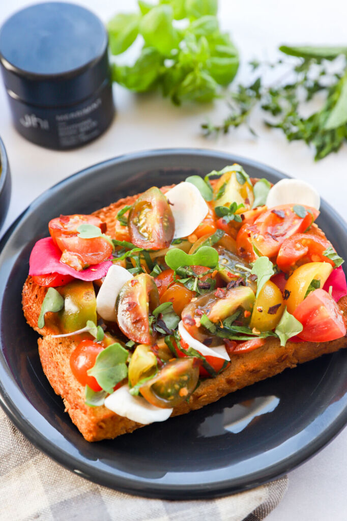 Healthy garden toast featuring fresh tomato and basil