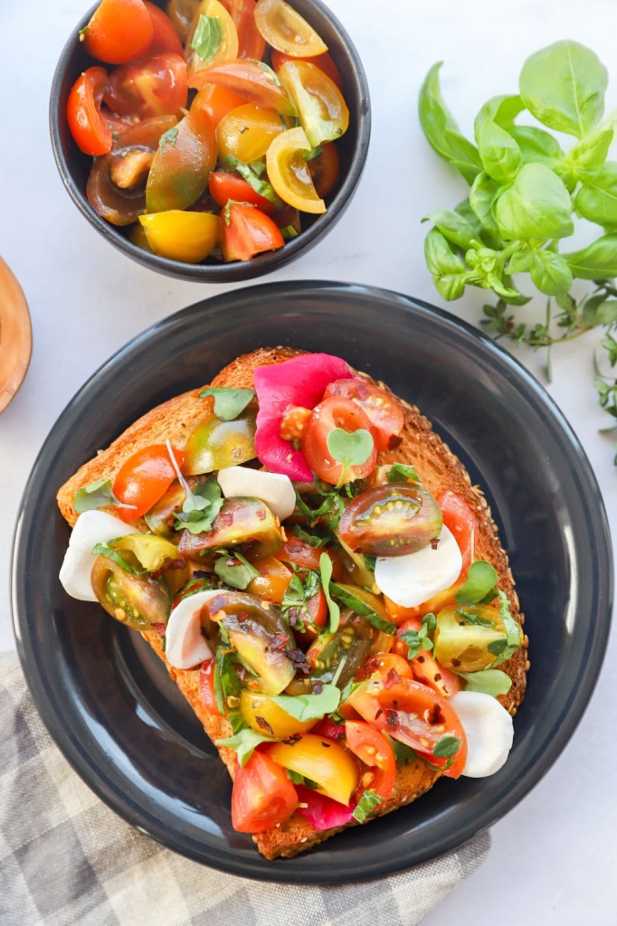 Healthy garden toast featuring fresh tomato and basil