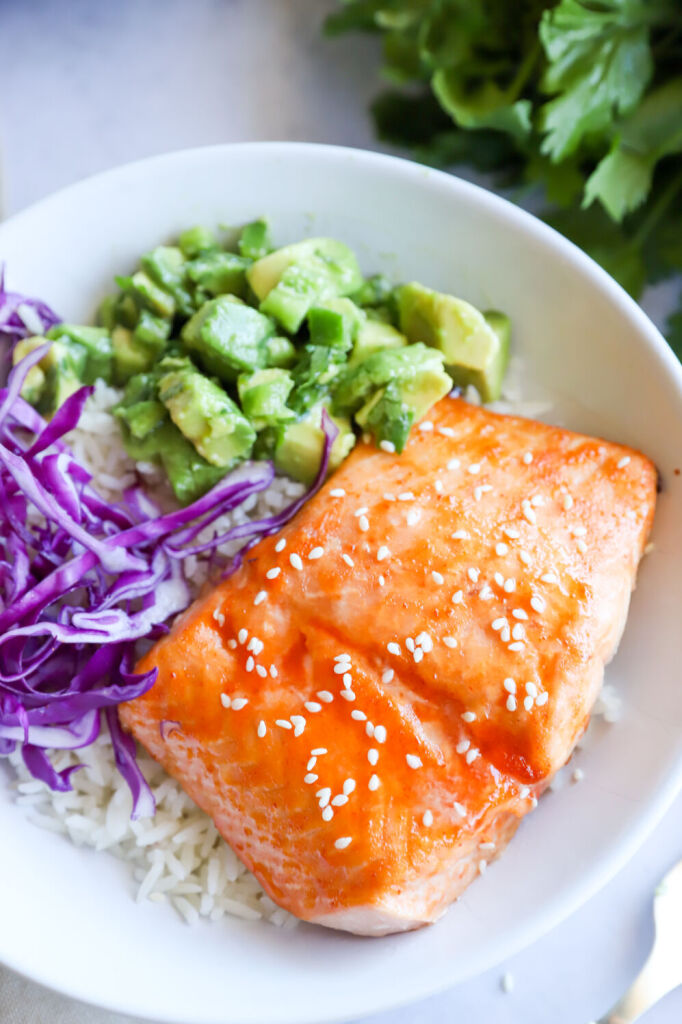 Air fryer honey glazed sriracha salmon served with fresh herbs