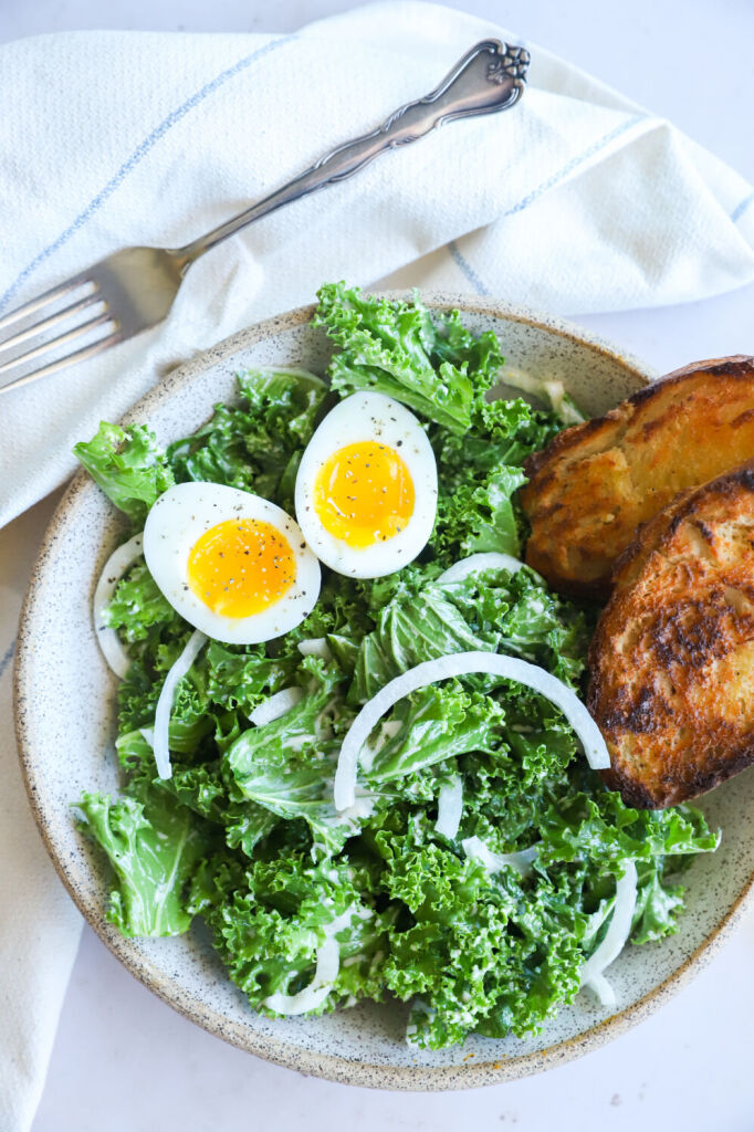 Kale Caesar salad with a poached egg and Parmigiano-Reggiano