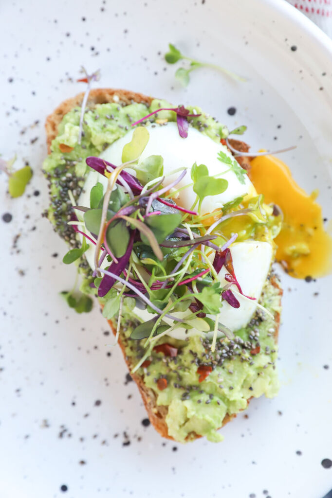 Avocado toast with microgreens, chia seeds, and a poached egg