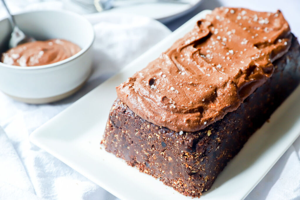 Gluten-free no-bake Nutella cake topped with hazelnuts