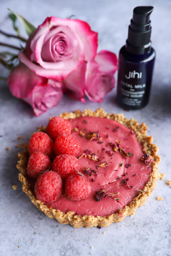 Mini raspberry rose tarts topped with fresh raspberries