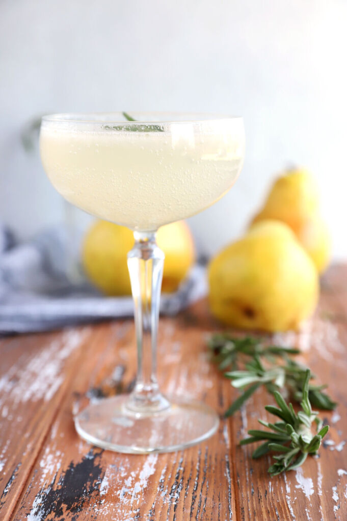 Refreshing rosemary pear mocktail with fresh pear and lemon slices