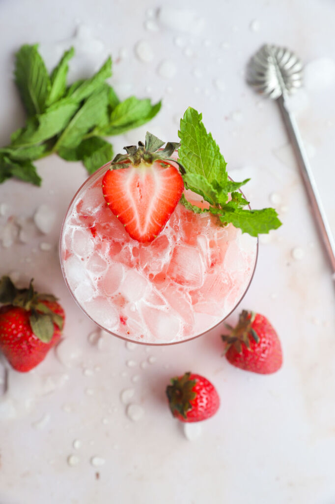 Refreshing strawberry kombucha mocktail with fresh strawberries and lime