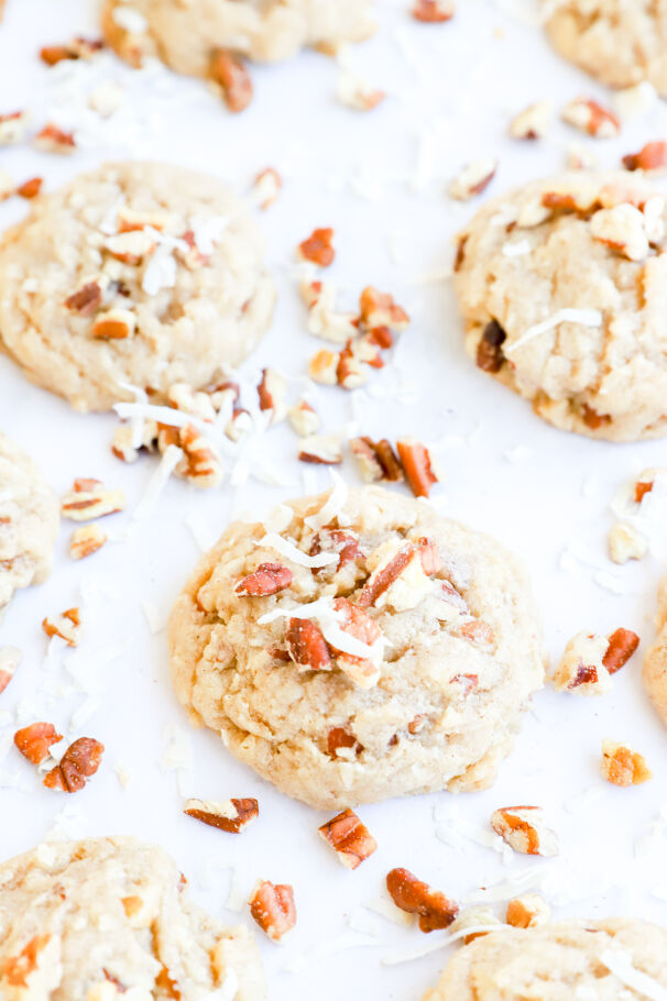 Gluten-free coconut pecan cookies on a lined baking sheet