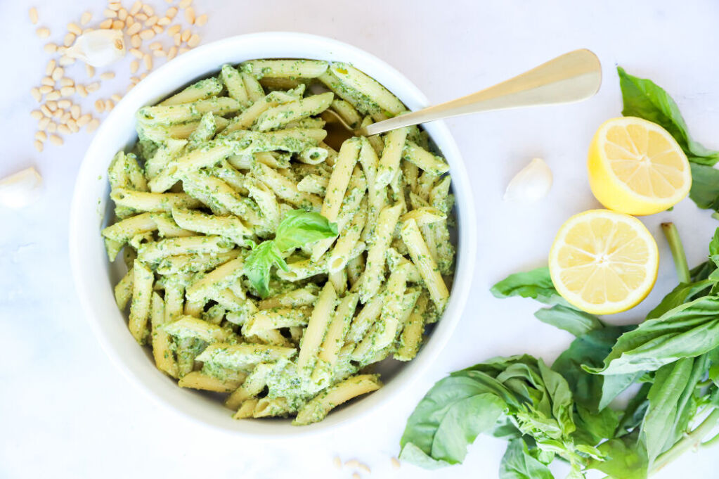 Creamy pesto pasta with chicken, pine nuts, and red pepper flakes