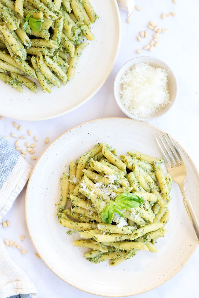 Healthy creamy pesto pasta dish with pine nuts and red pepper flakes