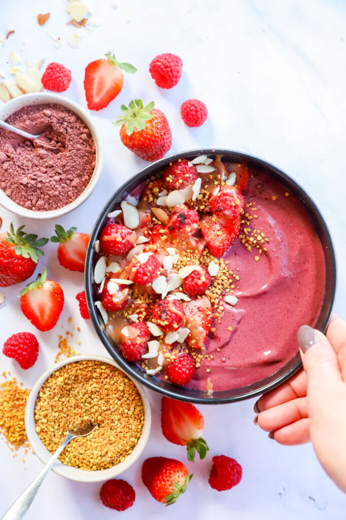 Fresh fruit and hibiscus smoothie bowl topped with chia seeds and almond butter