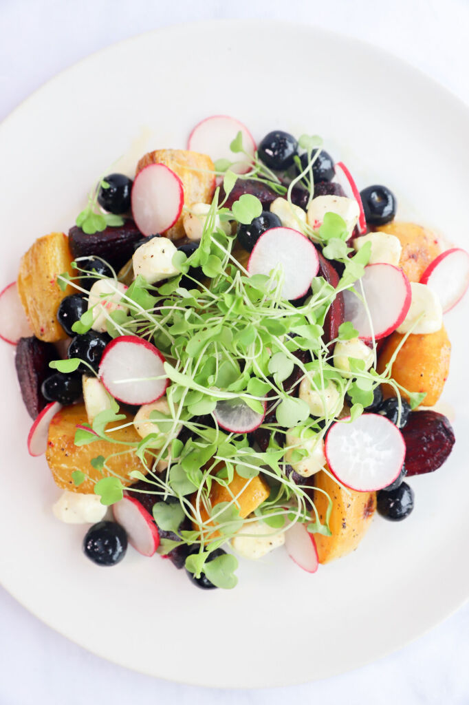 Golden beet salad with blueberries and mozzarella on a plate