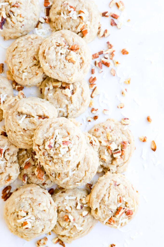 Gluten-free coconut pecan cookies on a lined baking sheet