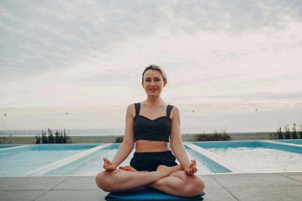 Women sitting in lotus pose smiling