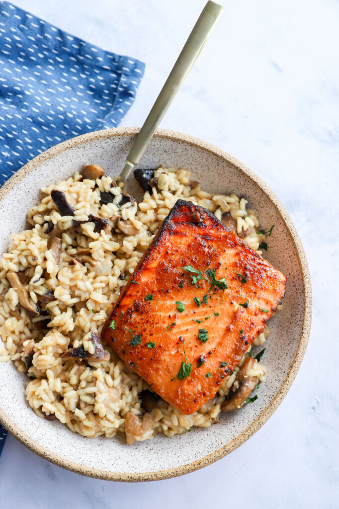 Miso glazed salmon on a bed of mushroom risotto with lemon and garlic