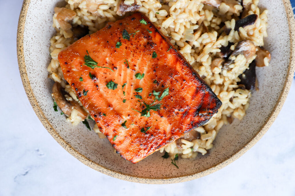 Healthy salmon risotto with miso glaze, arborio rice, and mushrooms