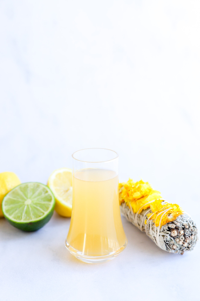 Close-up of Non-Alcoholic Green Tea Shot with lemon and lime slices