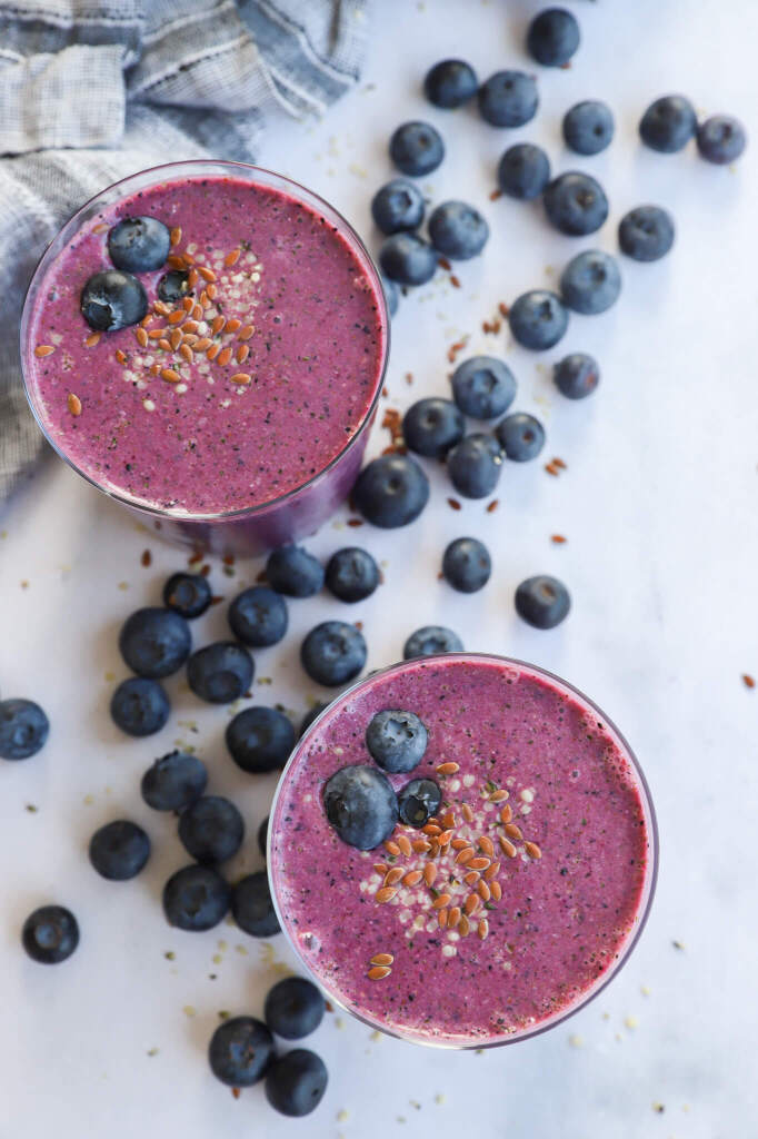 Hormone-balancing banana beet smoothie in a glass with fresh ingredients