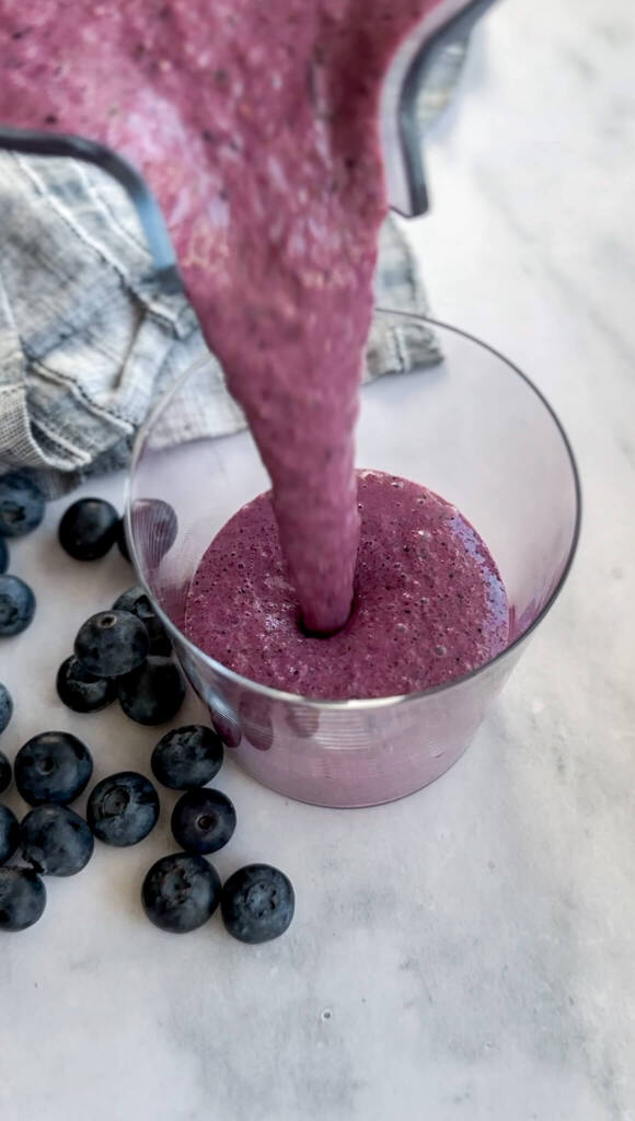 Healthy hormone balance banana beet smoothie in a glass with a straw