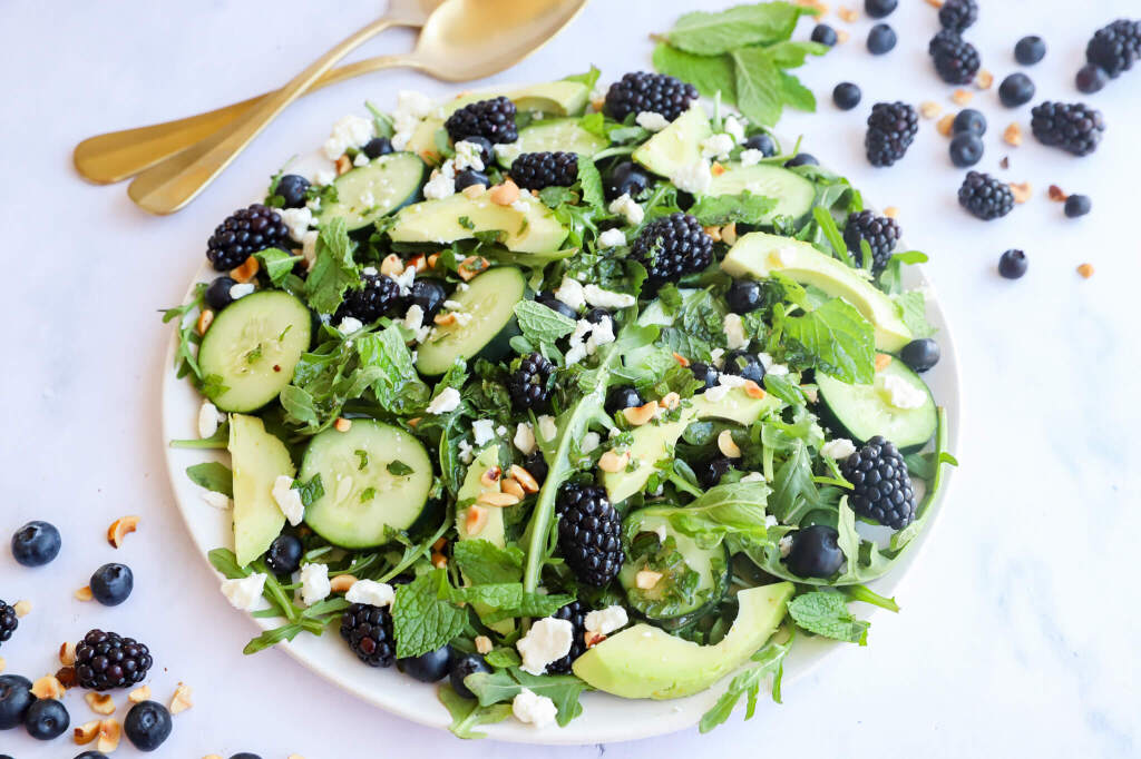 A bowl of fresh Blackberry, Avocado, and Arugula Salad for hormone balancing