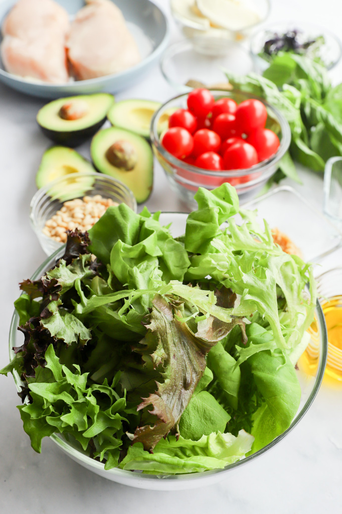 Process shot of preparing Chicken Avocado Caprese Salad