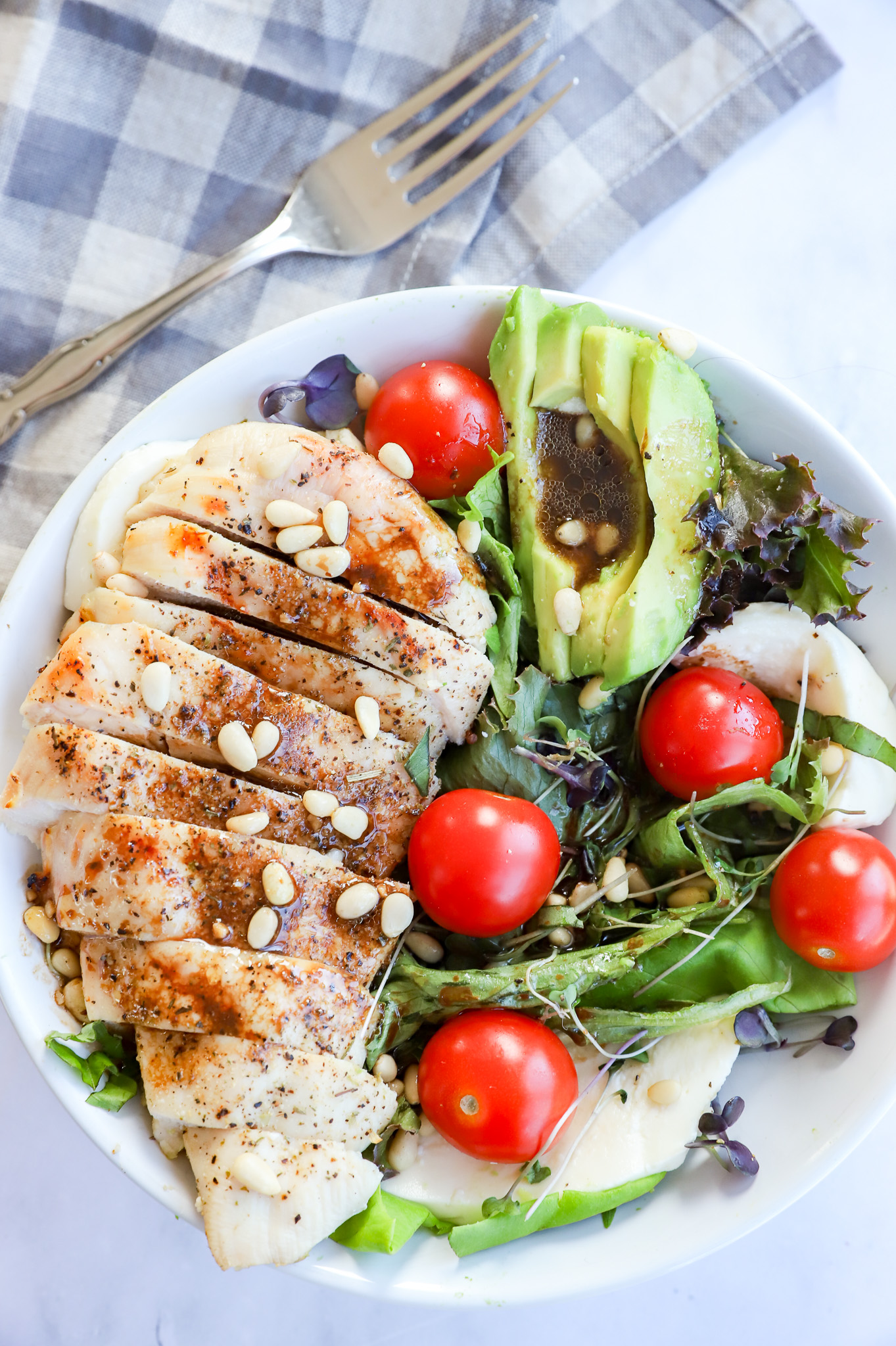 Vertical image of Chicken Avocado Caprese Salad with fresh ingredients