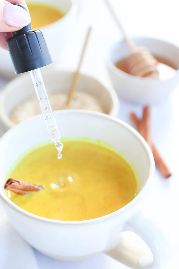 Golden Moon Milk in a cup with ingredients like turmeric and almond milk