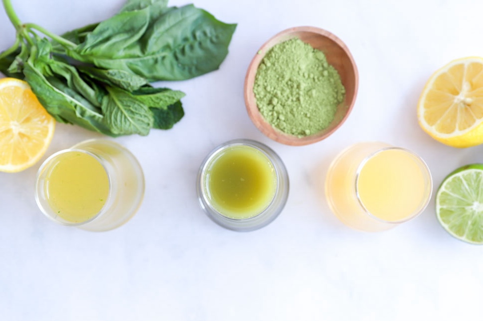 Close-up of Mint Basil Green Tea Shot with fresh mint and basil leaves