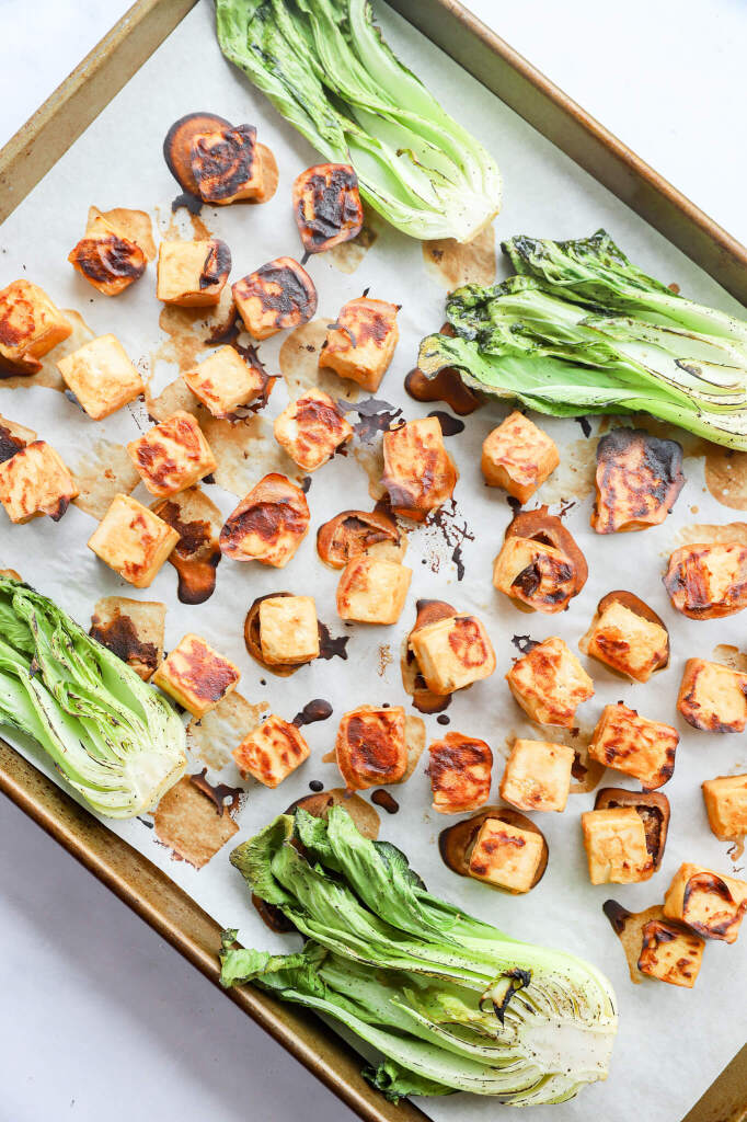 Baked miso tofu with bok choy on a white plate for hormone balance and cycle support