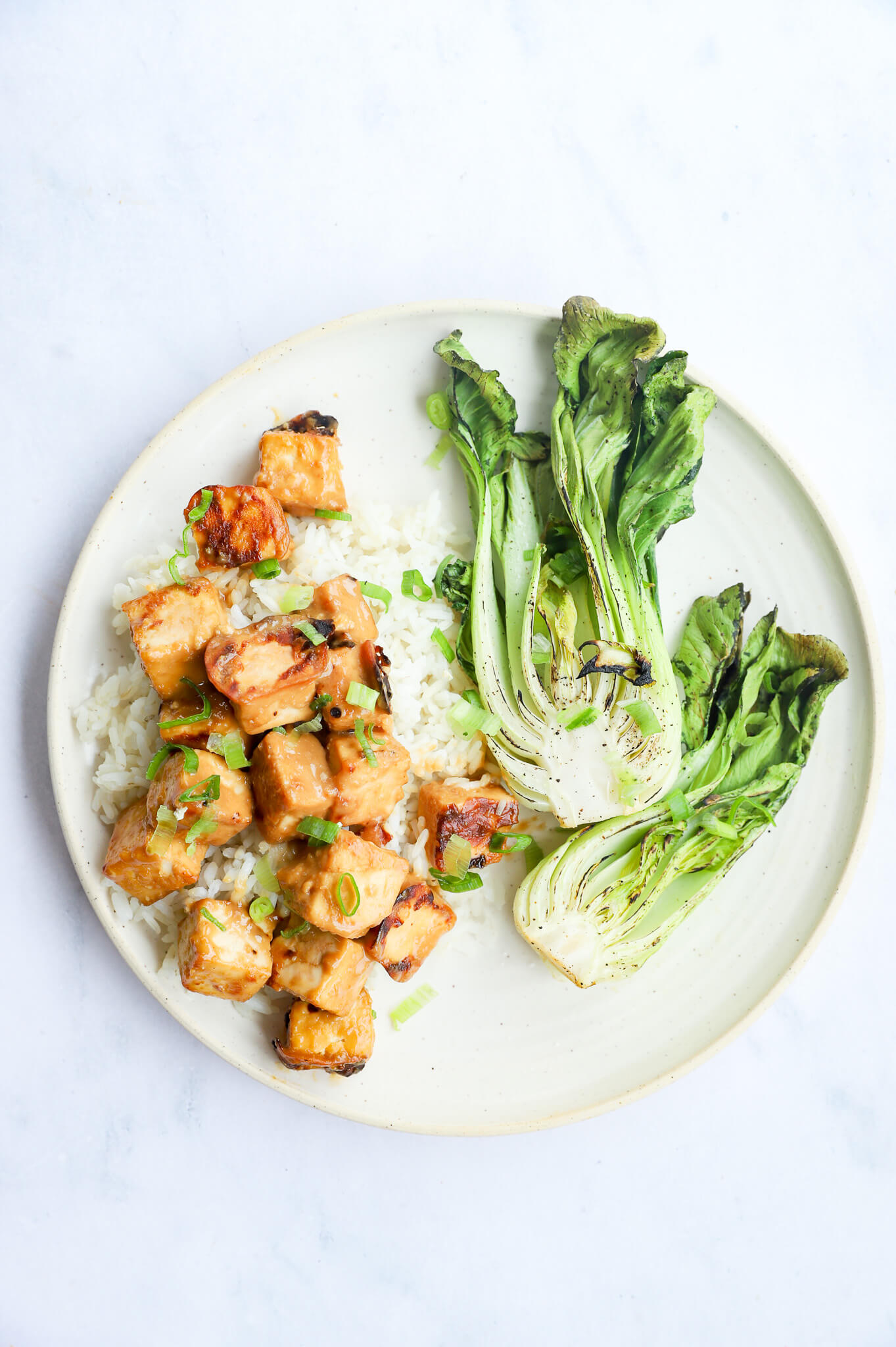 A plate of baked miso tofu with bok choy for hormone balancing