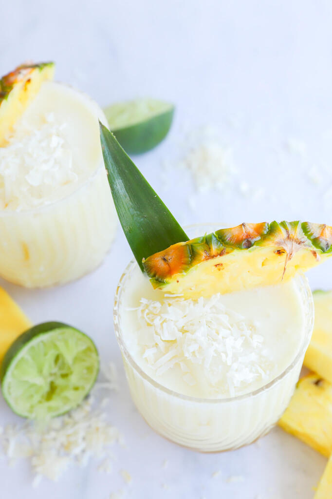 Hydrating pineapple coconut water mocktail in a glass with fresh pineapple