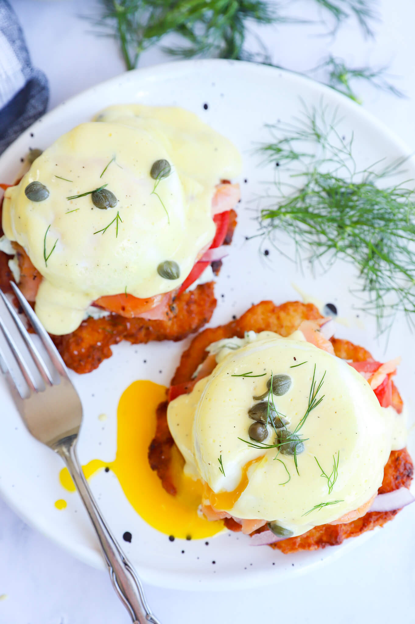 Gluten-free smoked salmon eggs benedict served over hashbrowns with hollandaise sauce