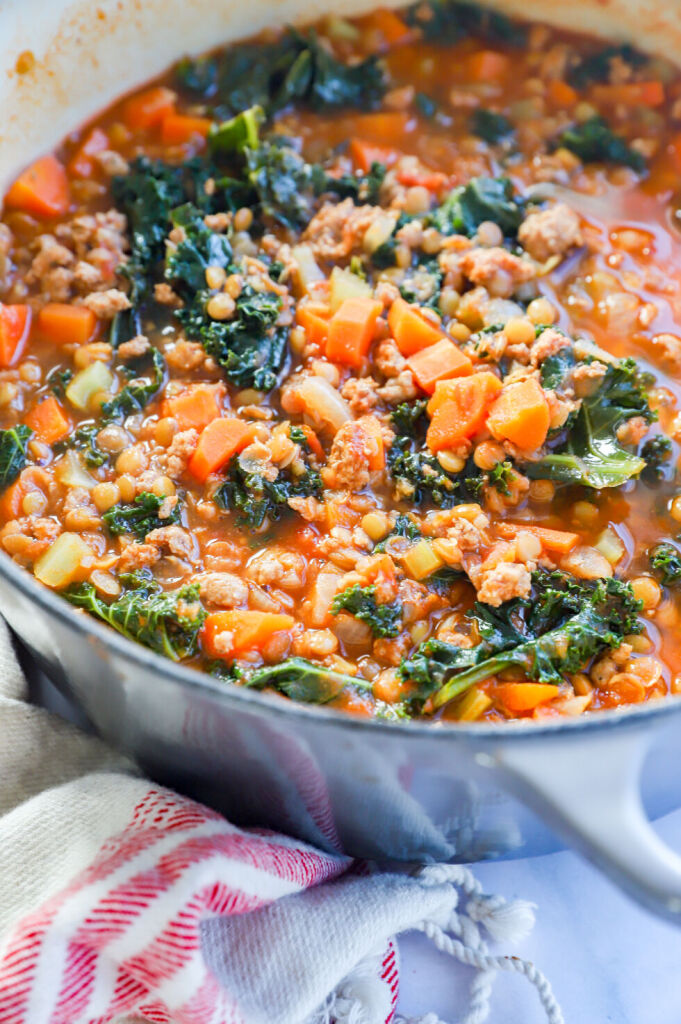 Bowl of hearty turkey lentil soup with celery, carrots, and onions