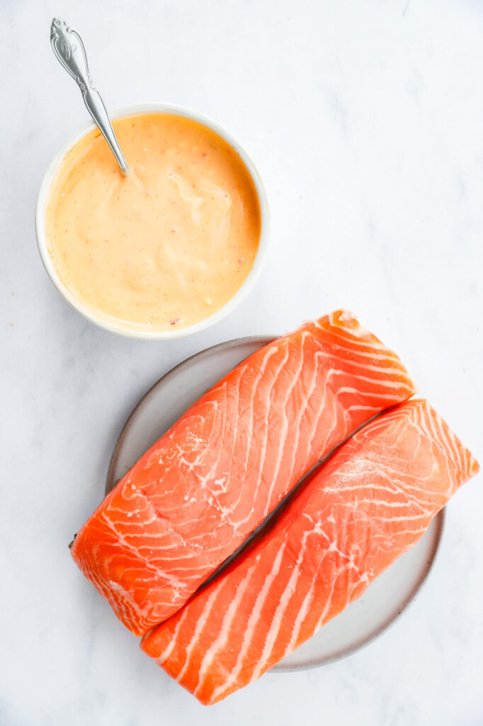 Close-up of crispy air fryer salmon bites with bang bang sauce