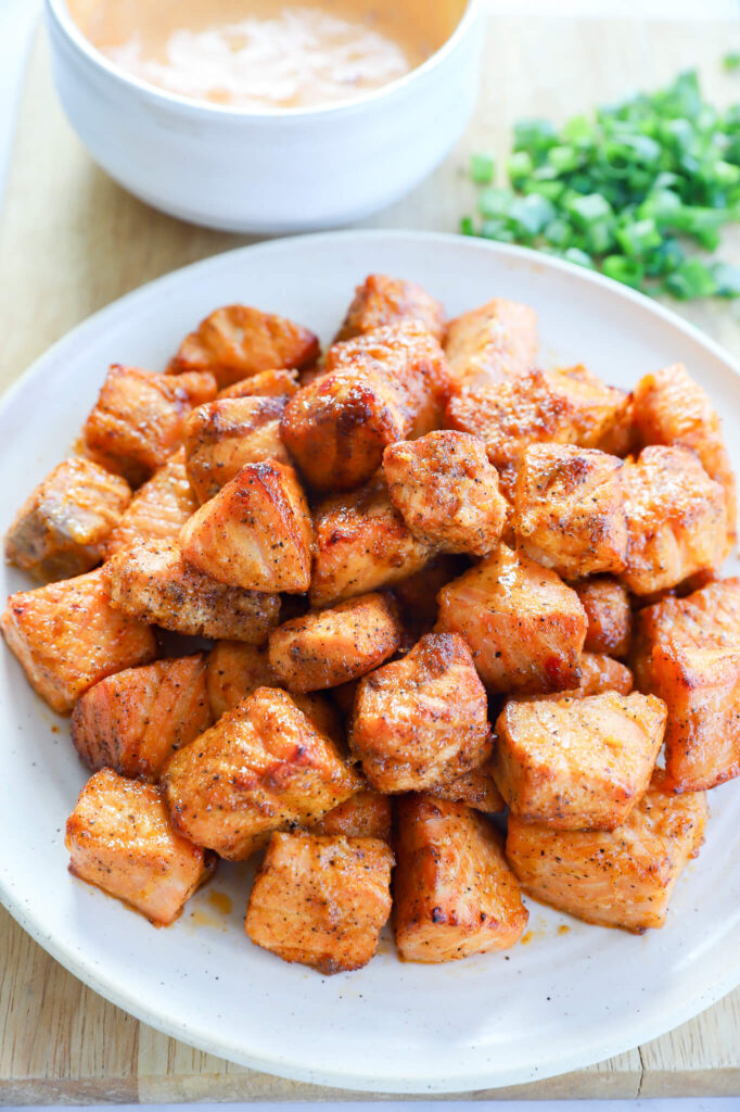 Step-by-step process of preparing bang bang salmon bites in the air fryer