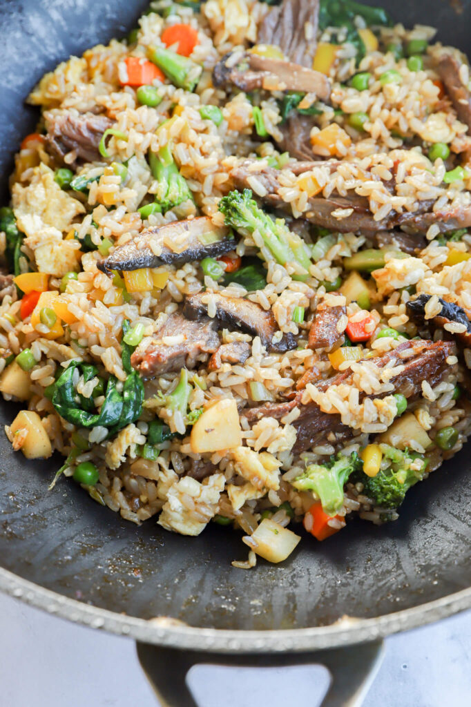 Beef fried rice served in a bowl with a fork on the side