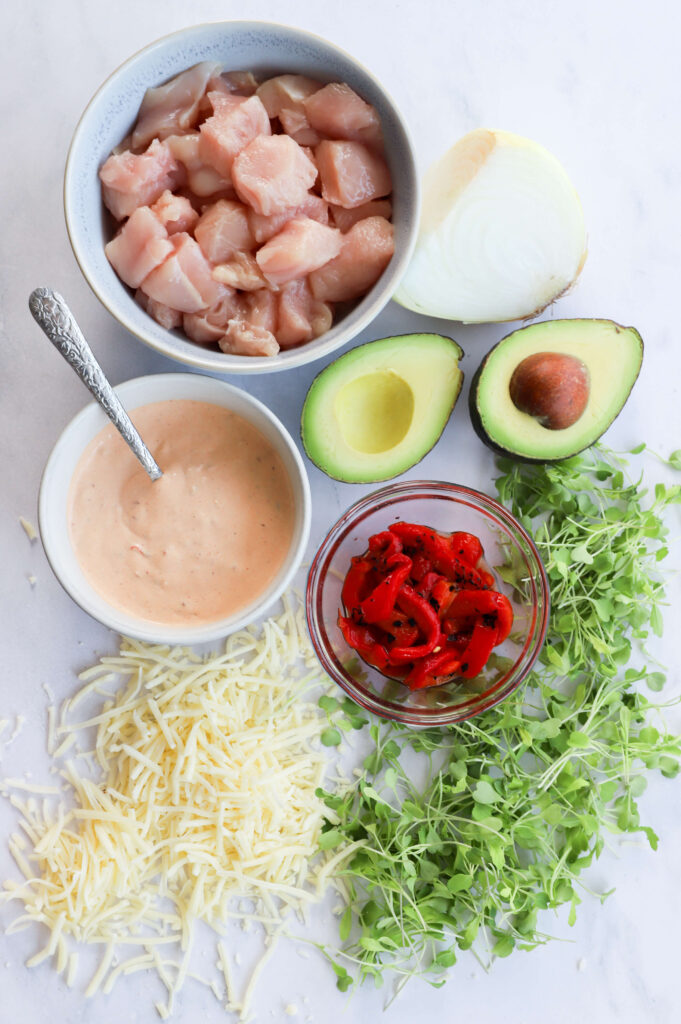 Ingredients for chipotle chicken avocado melt including chicken, avocado, cheese, and tortilla