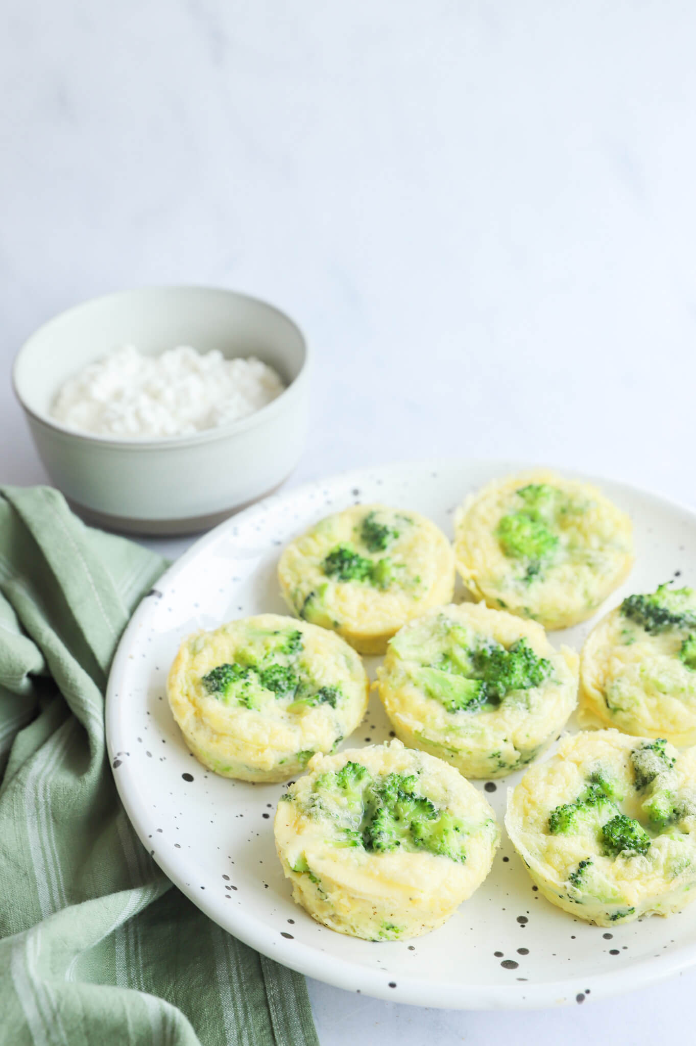 Broccoli egg bites with cottage cheese served on a plate