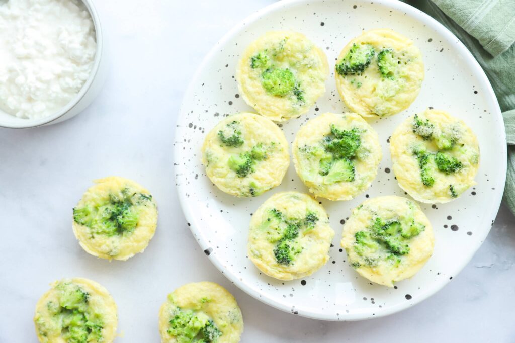 A plate of broccoli egg bites with cottage cheese served on a table