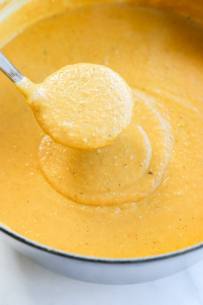 Close-up of French carrot lentil soup garnished with fresh parsley