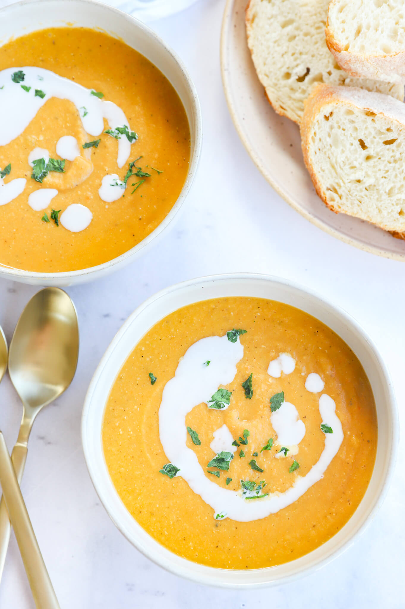 A bowl of French carrot lentil soup with fresh herbs