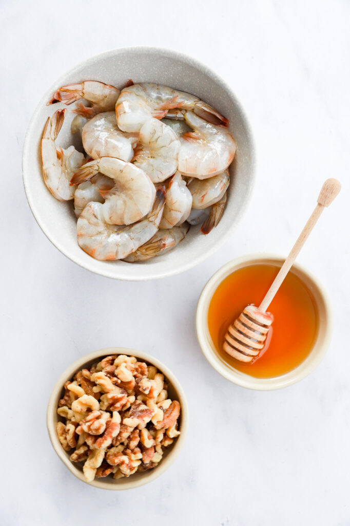 Ingredients for honey walnut shrimp including shrimp, walnuts, and honey