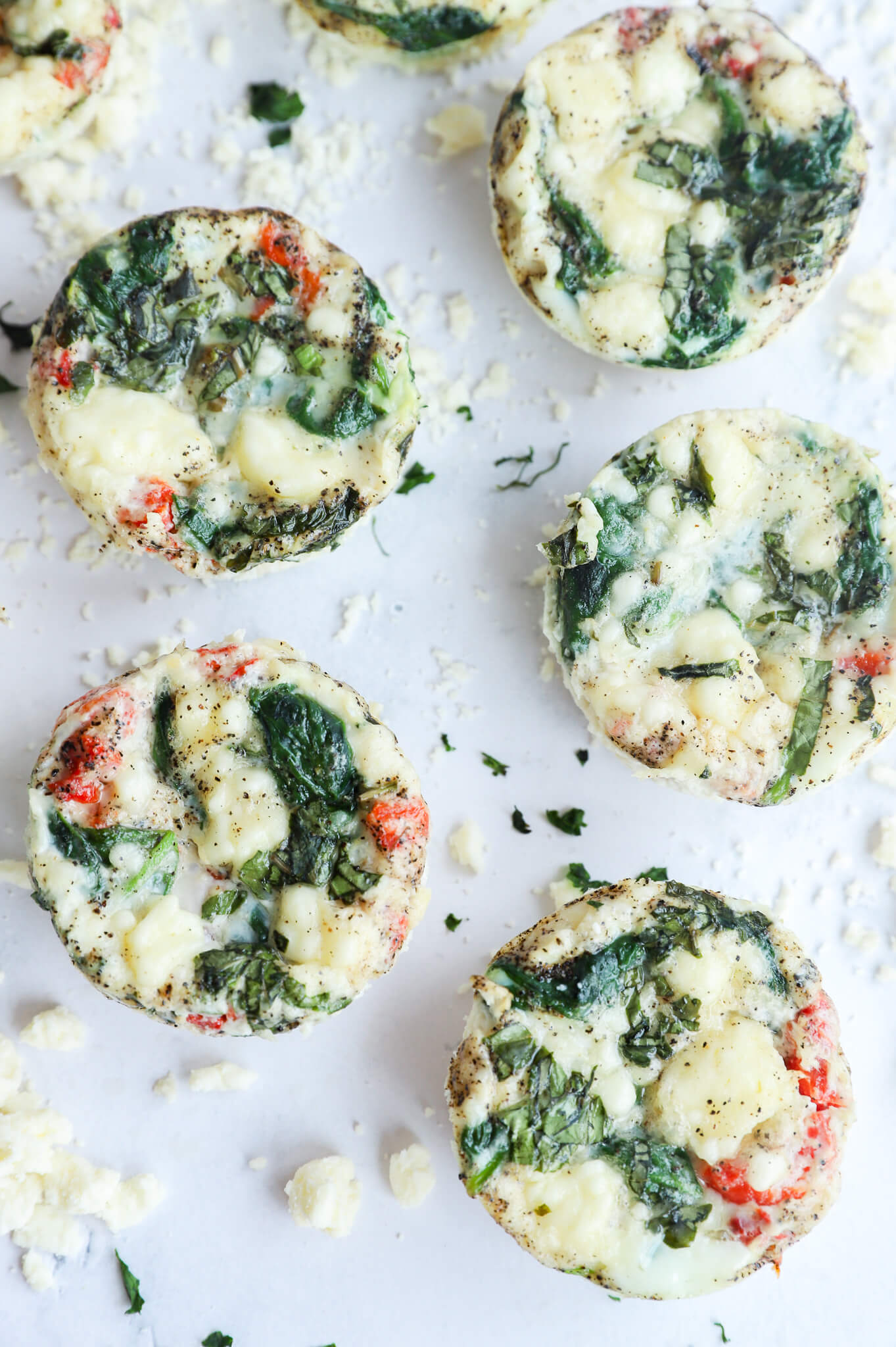 Delicious spinach and feta egg white bites on a plate, perfect for a healthy breakfast or snack.