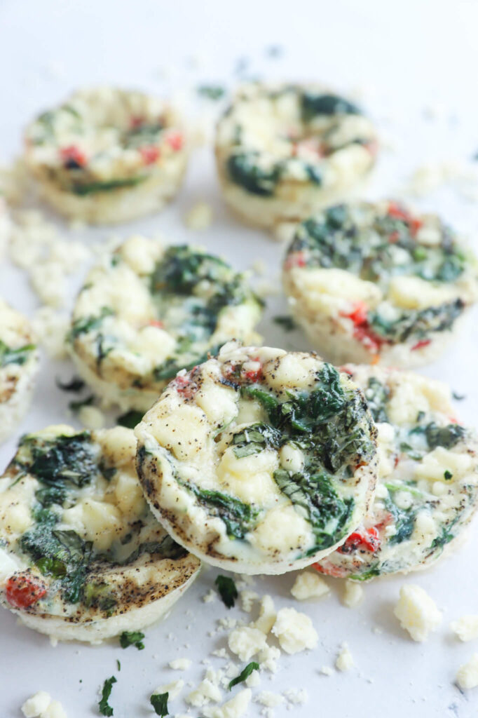 Close-up of spinach and feta egg white bites, showing the fluffy texture and golden edges.